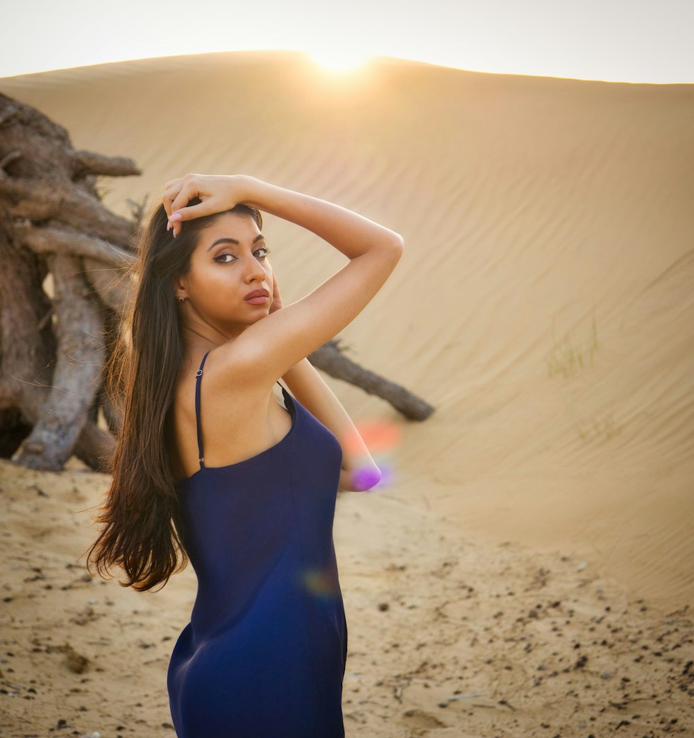 a woman posing in a blue dress