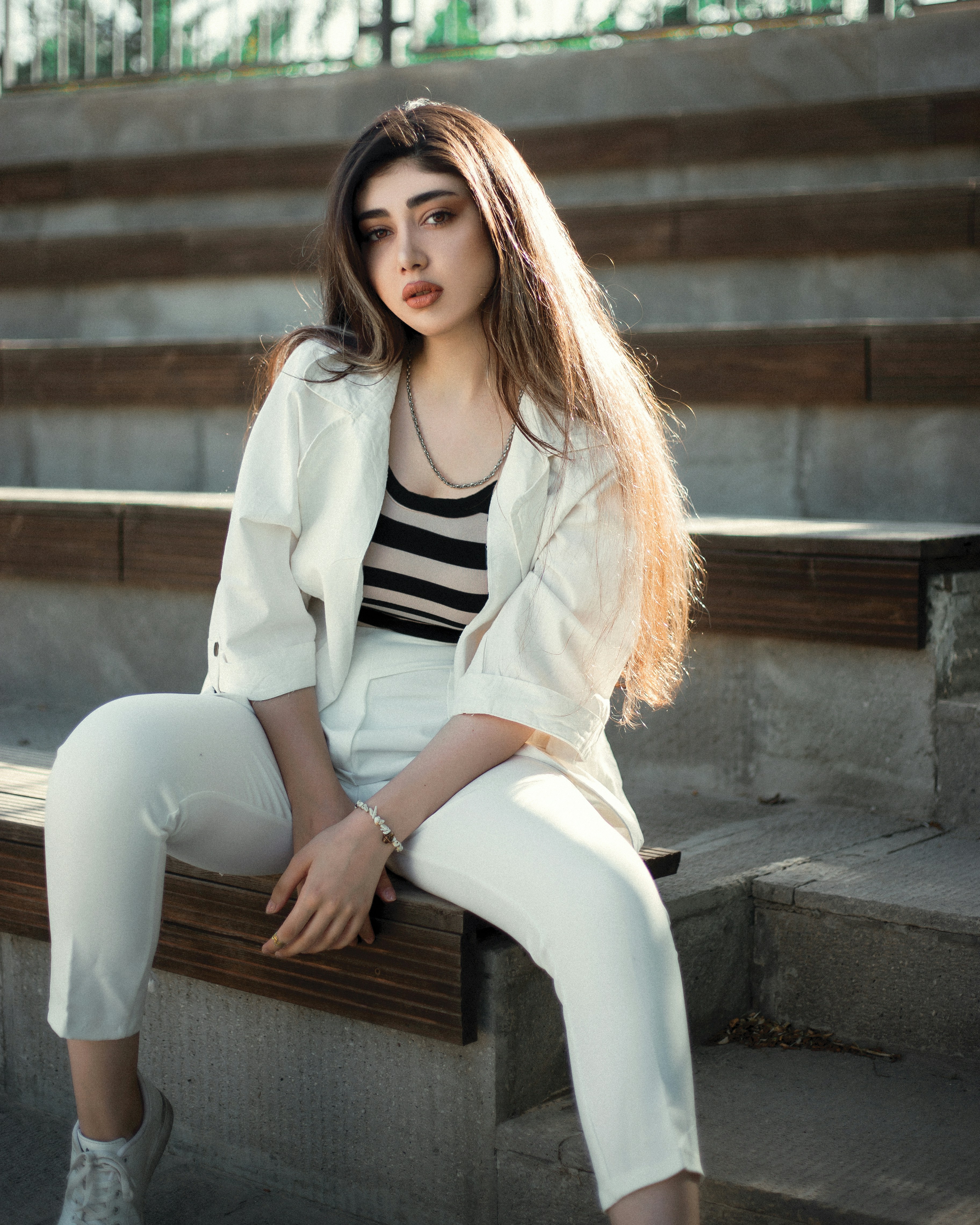 a woman sitting on a stone ledge