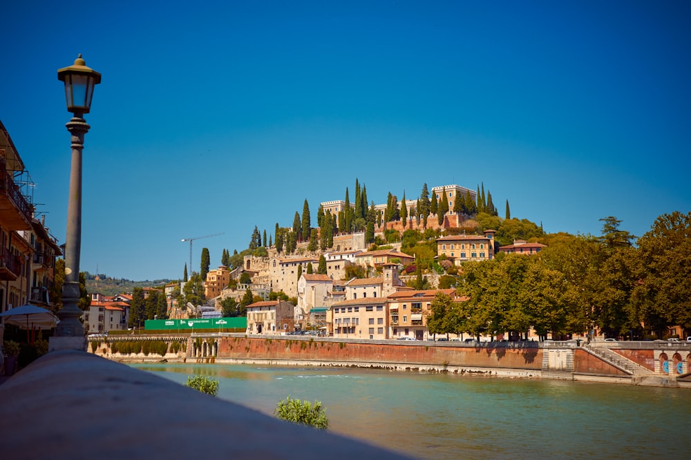 a body of water with buildings and trees around it