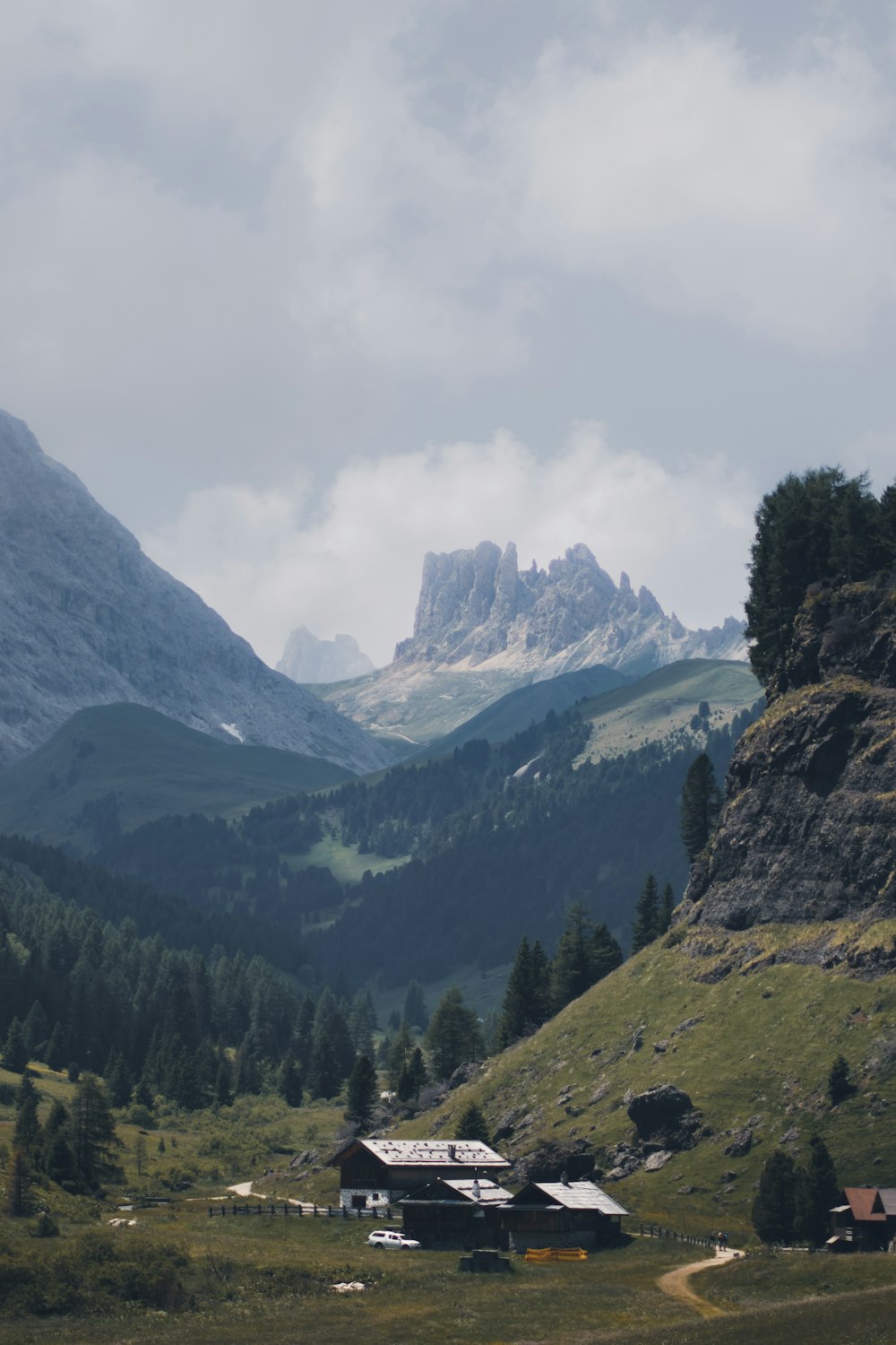 a building in a valley between mountains