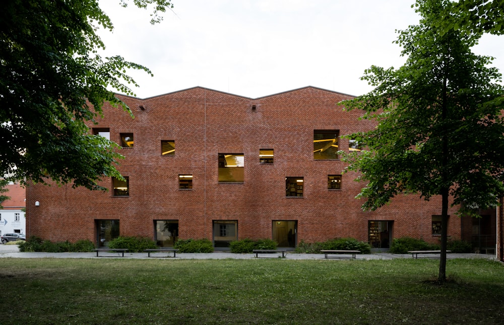 a brick building with trees in front