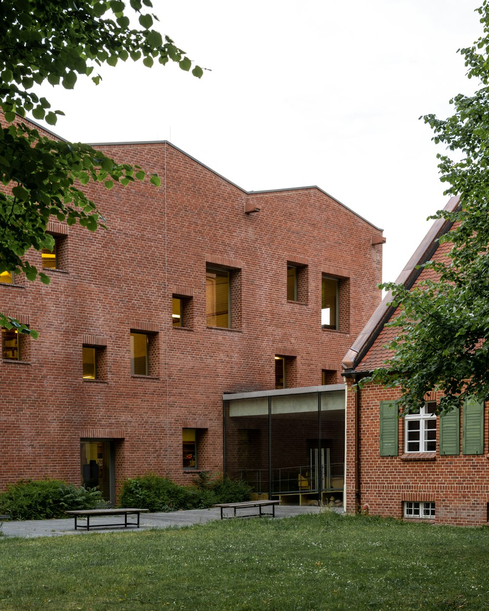 a brick building with a green lawn