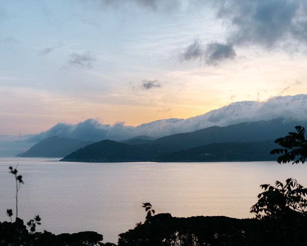 a body of water with mountains in the background