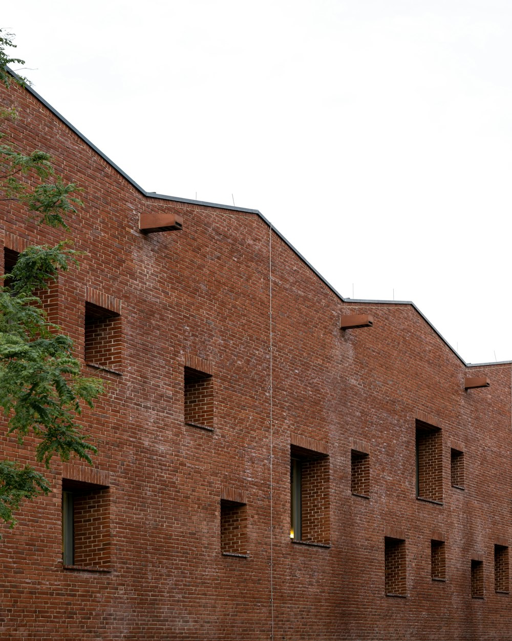 a brick building with a tree in front of it