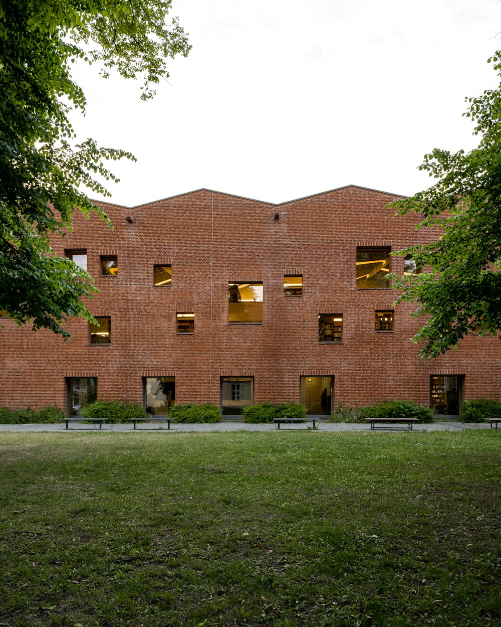 a brick building with a grass lawn