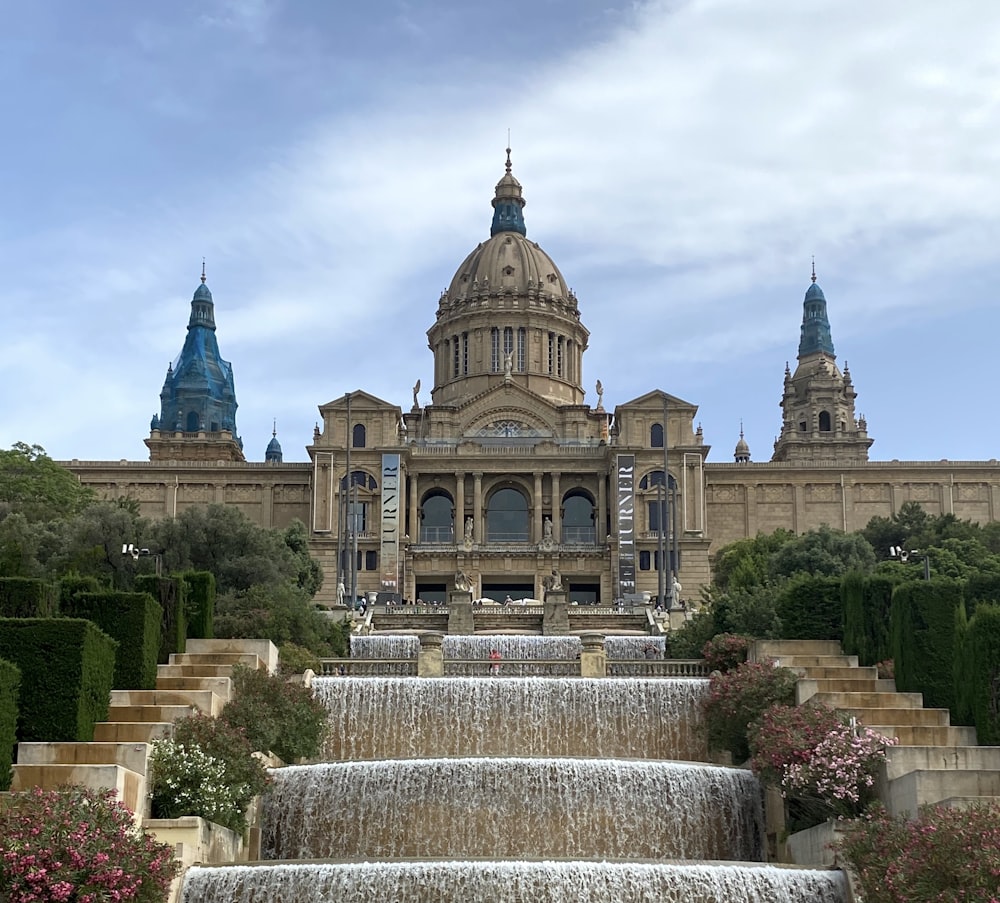 a large building with a fountain in front of it with Museu Nacional d'Art de Catalunya in the background