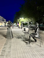 Intimate portrait of Gertrudis Martin Laprade, surrounded by her outdoor art installations.