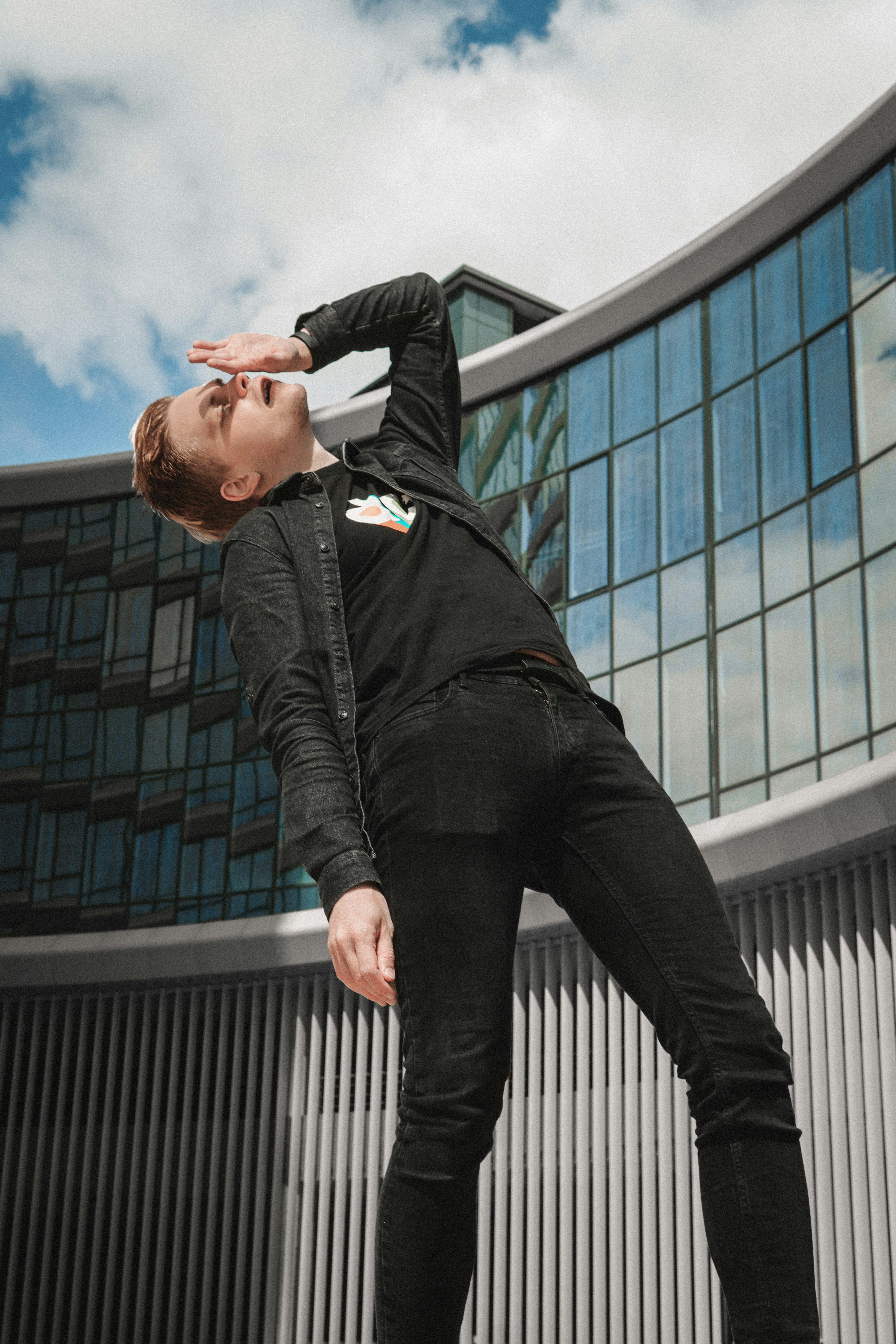 a person in a uniform leaning on a railing with the hand on the head