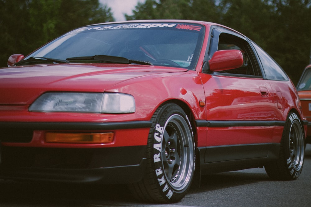 a red car parked on pavement