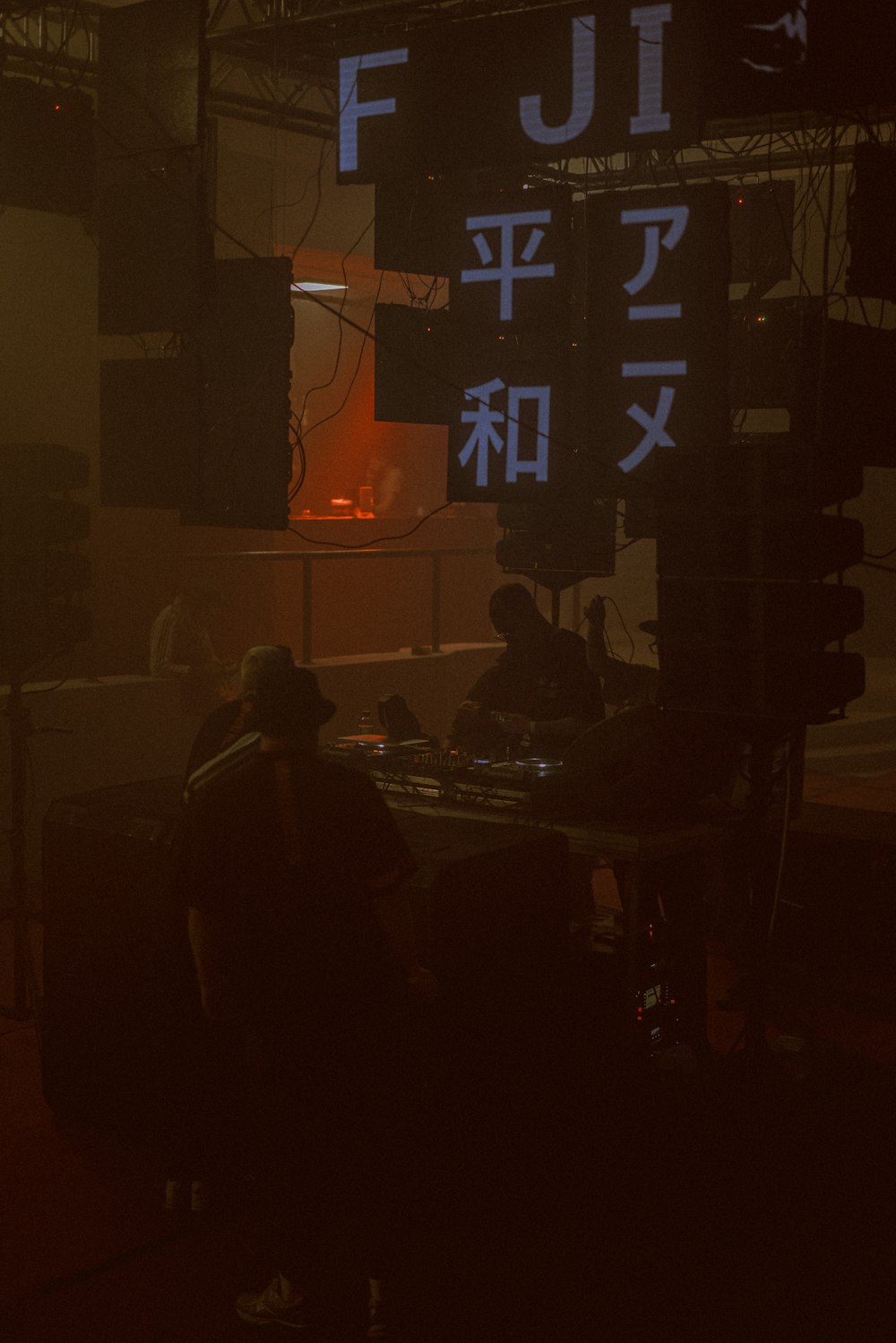 a group of people sitting at a table in front of a large screen