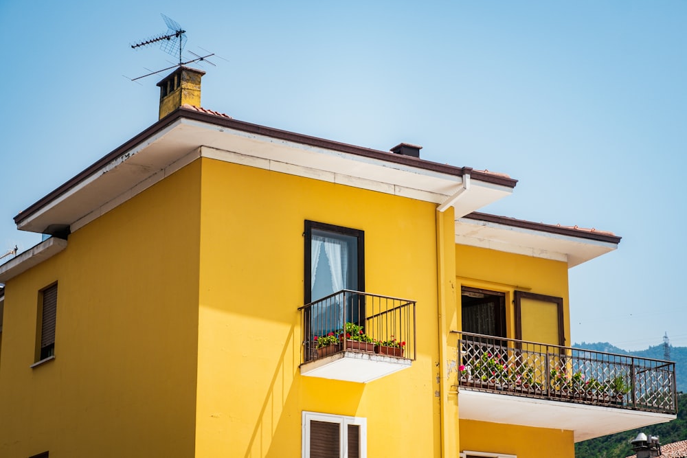 a yellow house with a balcony