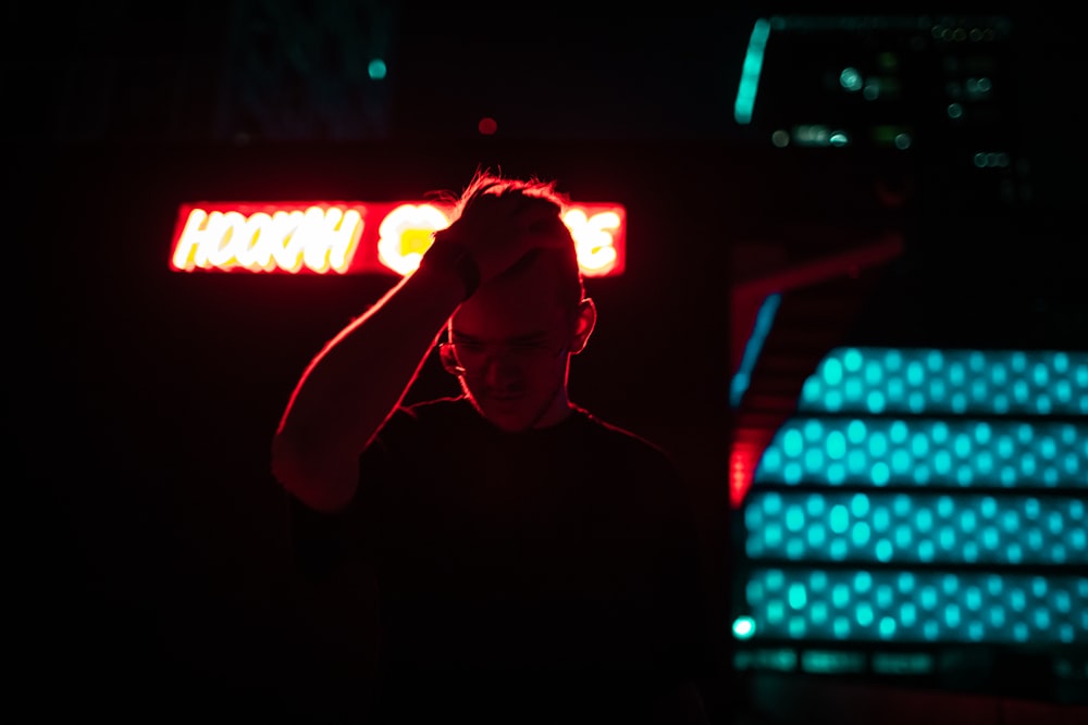 a person holding a sign in front of a dj booth