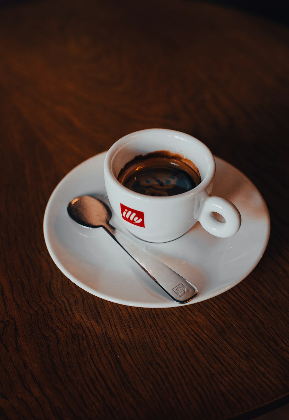 a cup of coffee and a spoon on a saucer