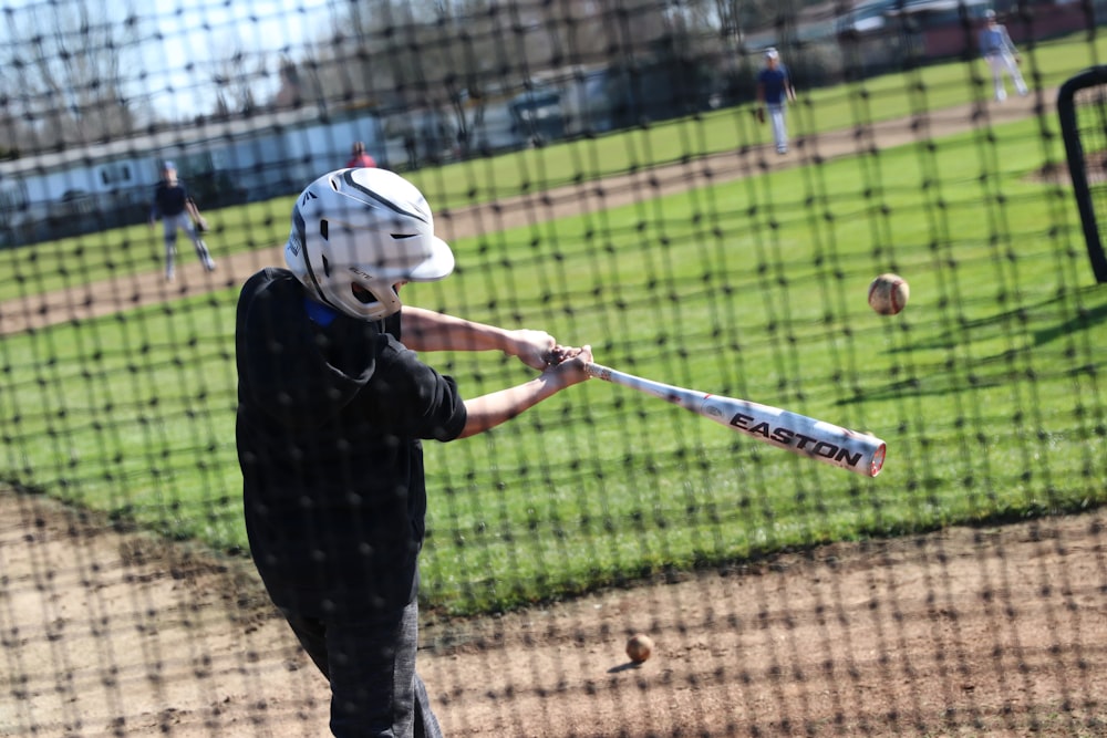 a kid swinging a baseball bat