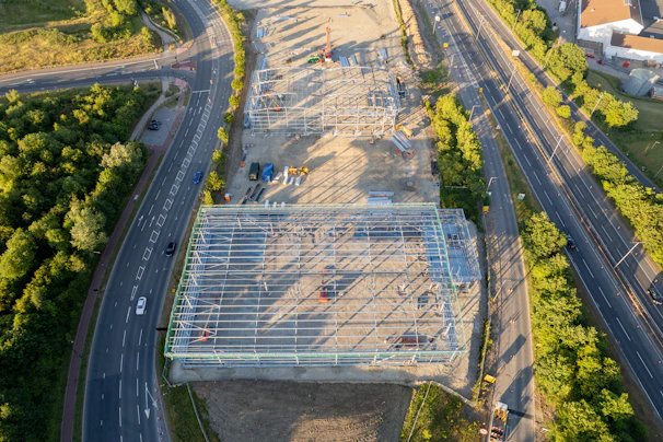 Aerial view of a sprawling construction site with clear topographic details under bright daylight.