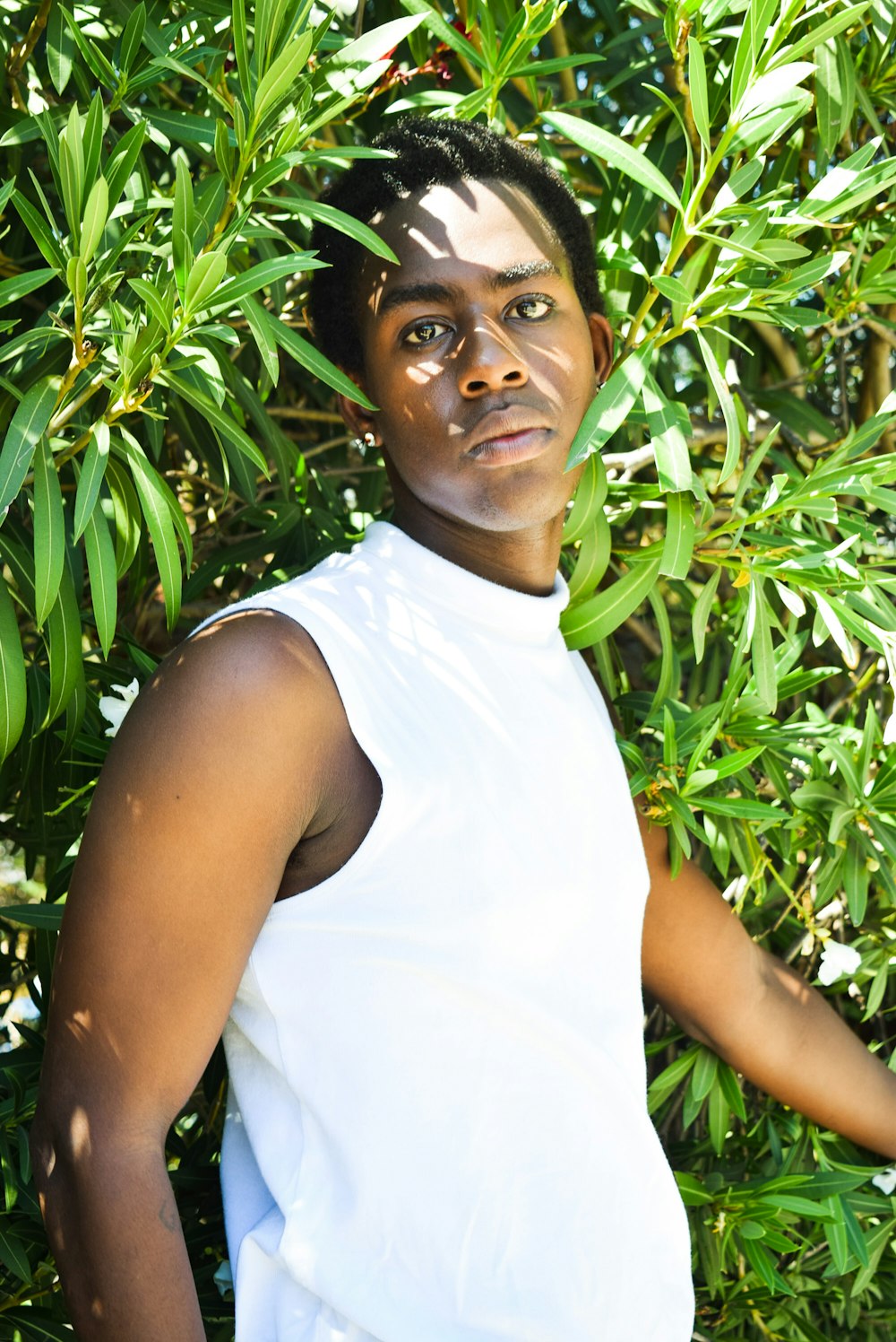 a woman standing in front of a bush