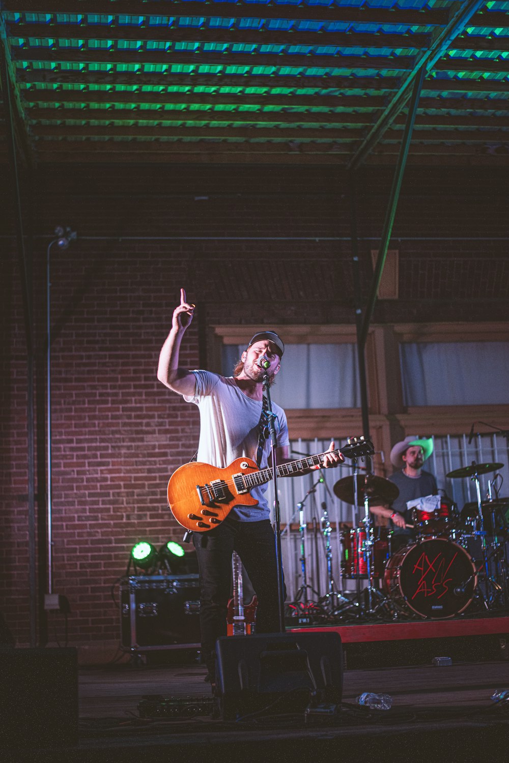 a man playing a guitar on a stage