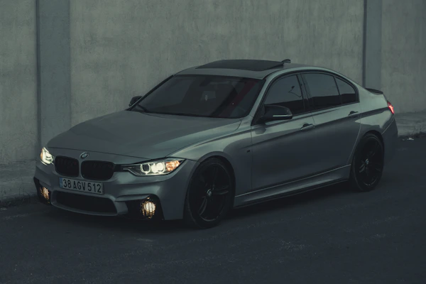 Elegant BMW sedan parked in an urban setting highlighting its signature kidney grille.