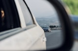 A scenic view of a learner driver practicing on a quiet road surrounded by Swiss countryside.