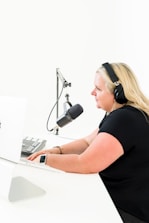 a woman wearing headphones and using a laptop