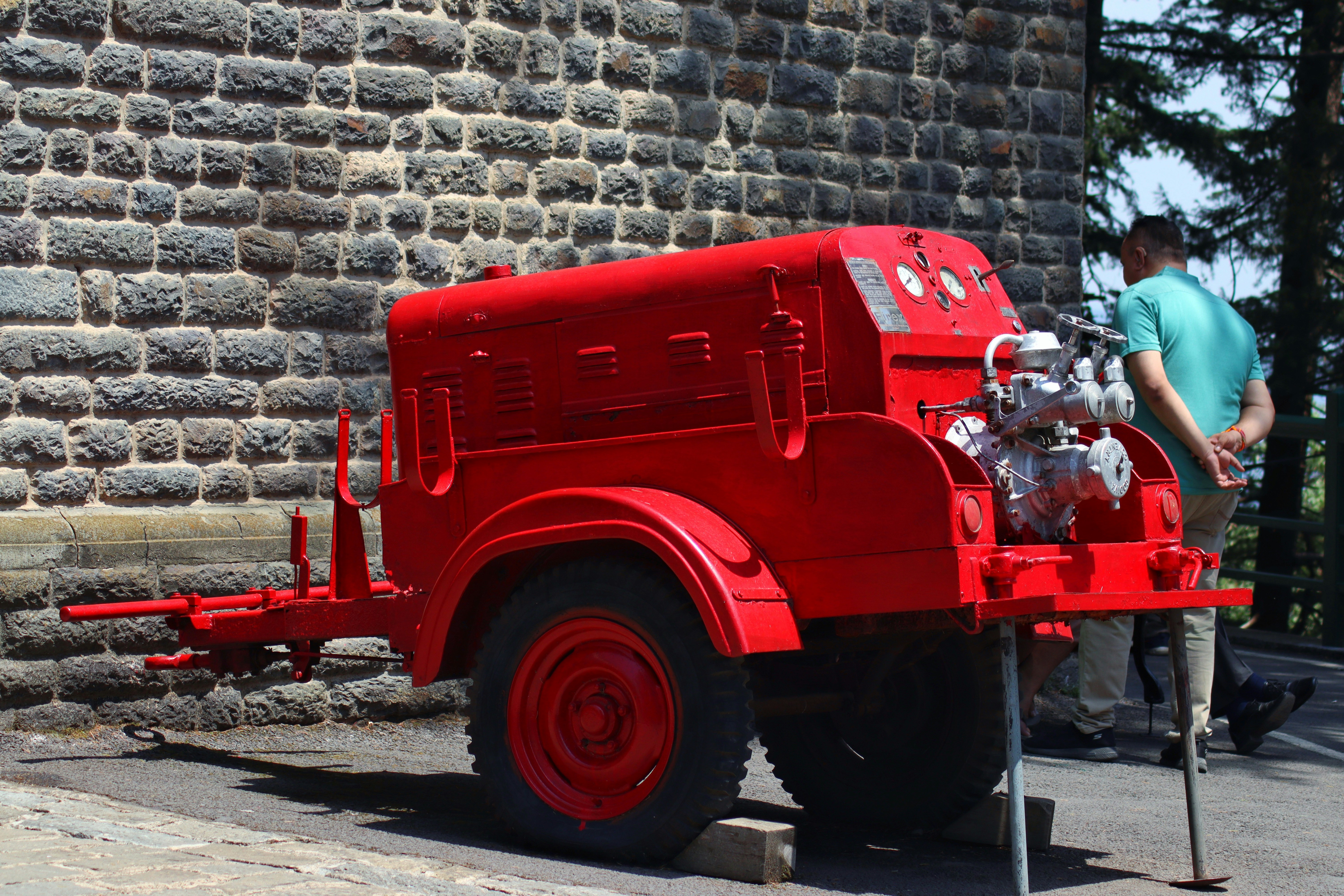 a person standing next to a red truck