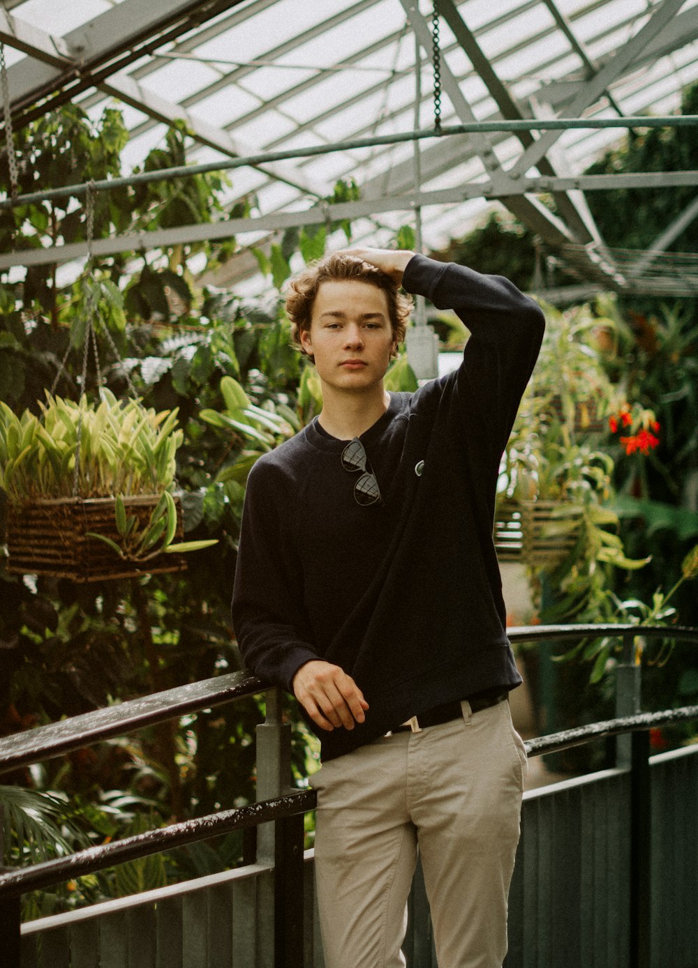 a man standing in a greenhouse