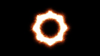 A vibrant Aries symbol glowing with fiery red and orange hues against a dark cosmic background.