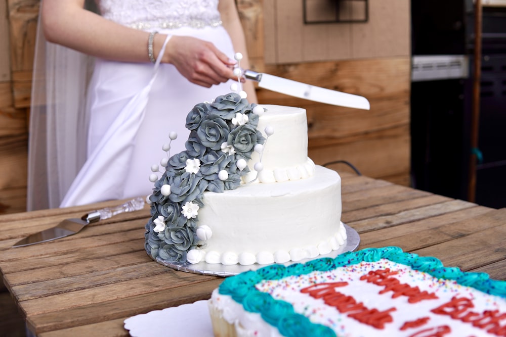 a bride and groom cut a wedding cake