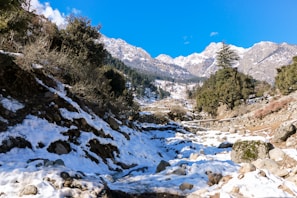 a river running through a snowy valley