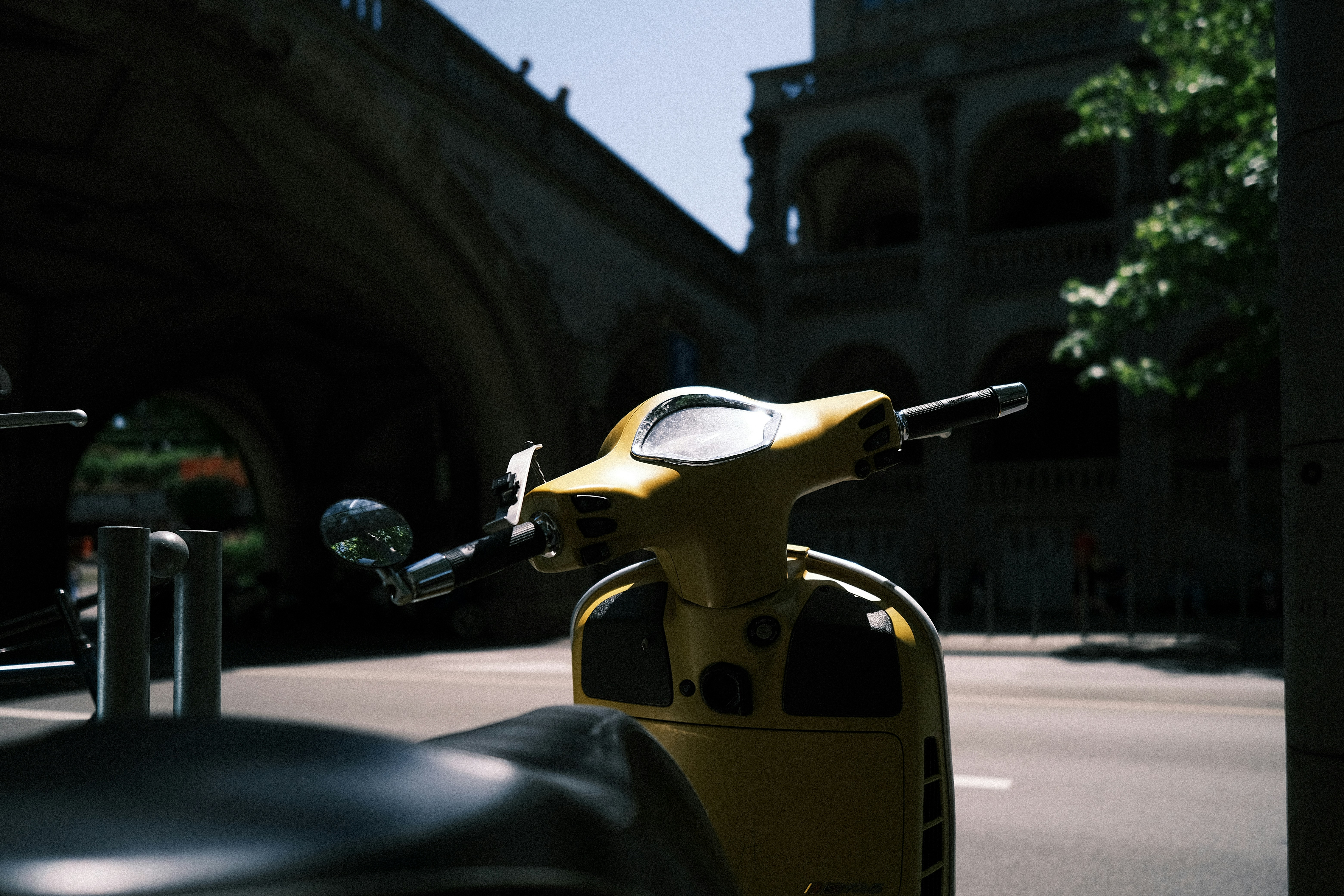 A yellow scooter parked on the side of a street photo Free Zurich
