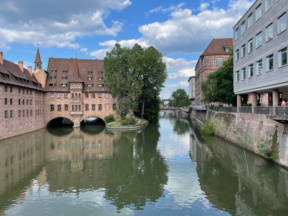 a river with buildings along it with Bruges in the background