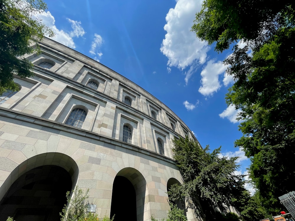 a stone building with trees and blue sky