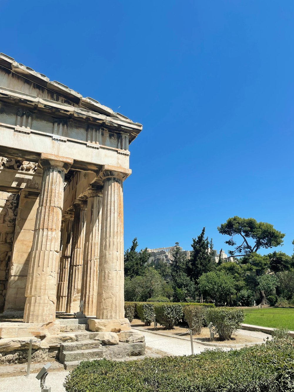 a building with columns and a garden