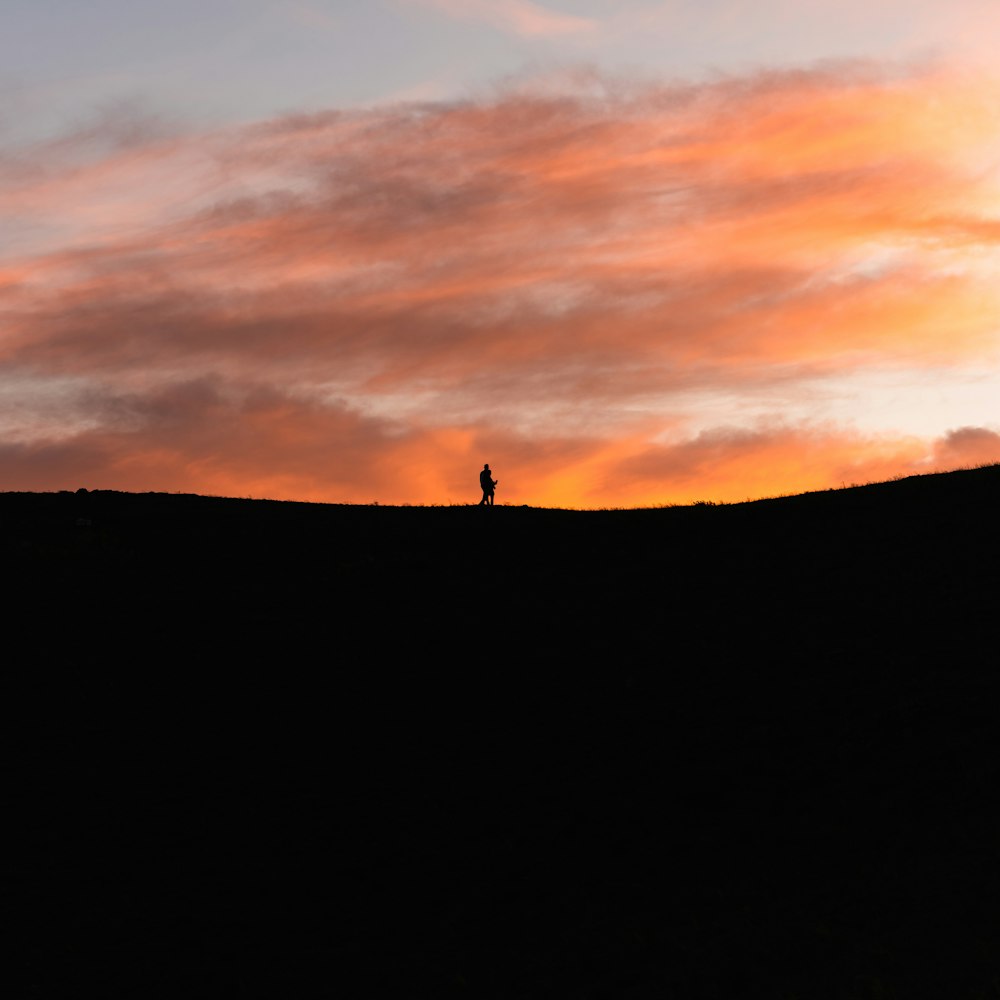 a person standing on a hill