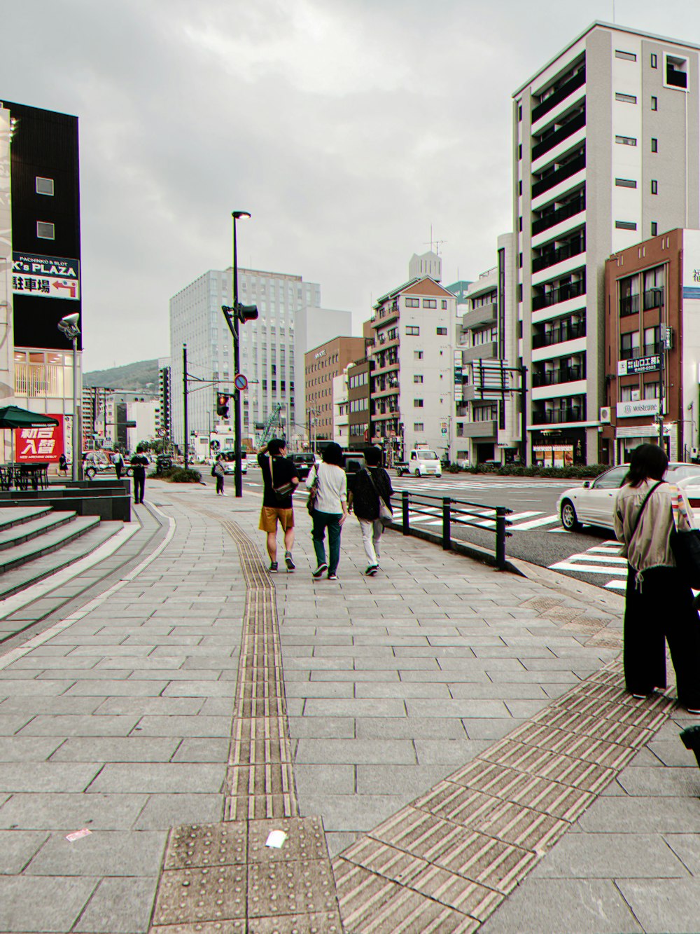people walking on a sidewalk