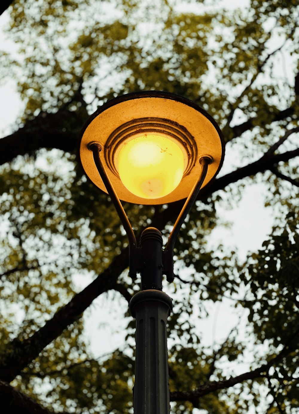 a yellow light on a pole