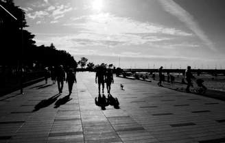 a group of people walking on a boardwalk