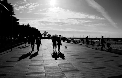 a group of people walking on a boardwalk