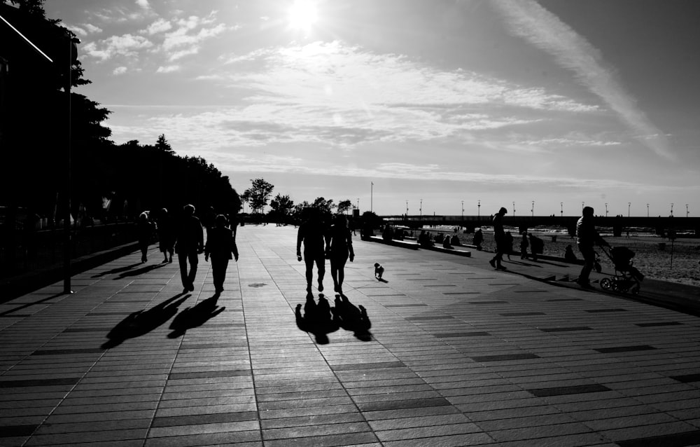 a group of people walking on a boardwalk