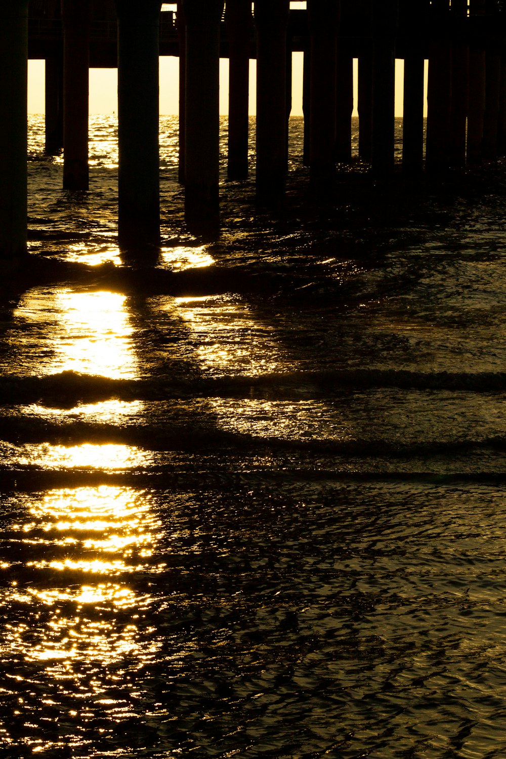 a wooden dock with a light shining through it