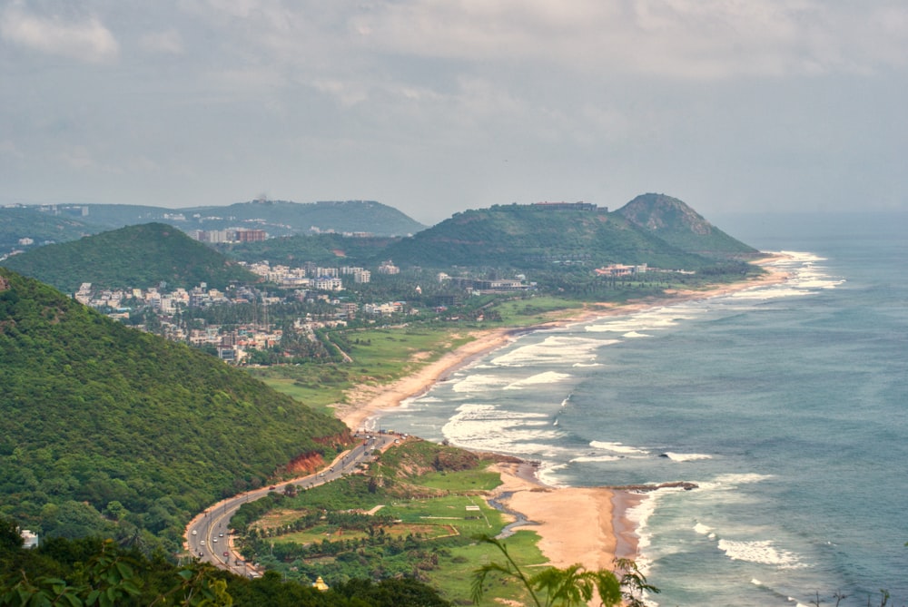 a beach with a town by the ocean