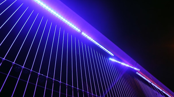 Futuristic AI-inspired pattern with geometric shapes illuminated in electric blue and violet.