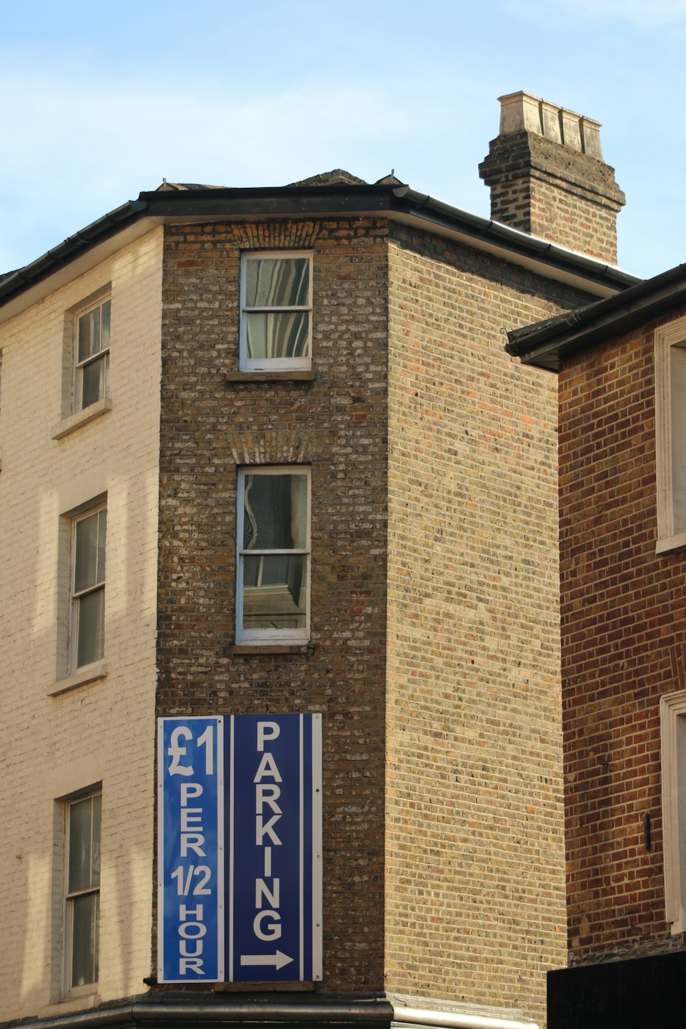 a brick building with a sign on it