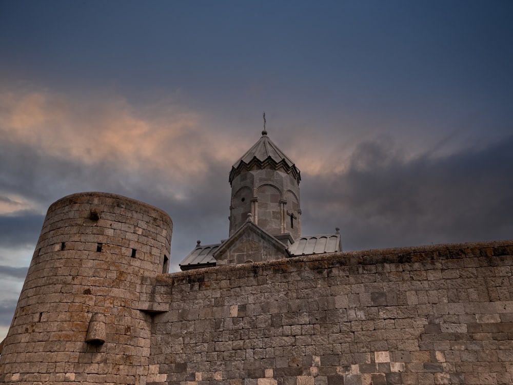 a stone wall with a tower