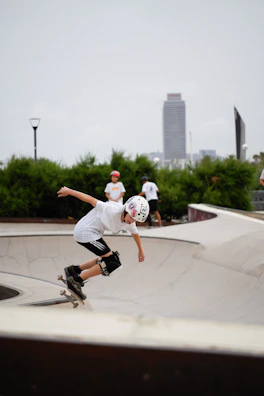 Young skater performing a kickflip on a professional shortboard at a city skate park