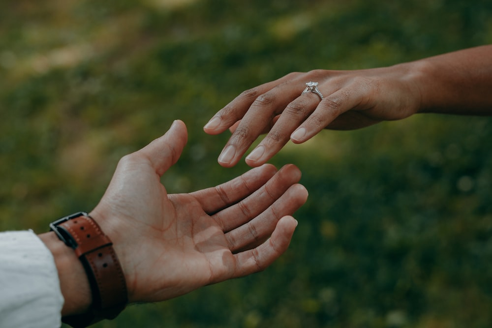 a couple of hands holding each other