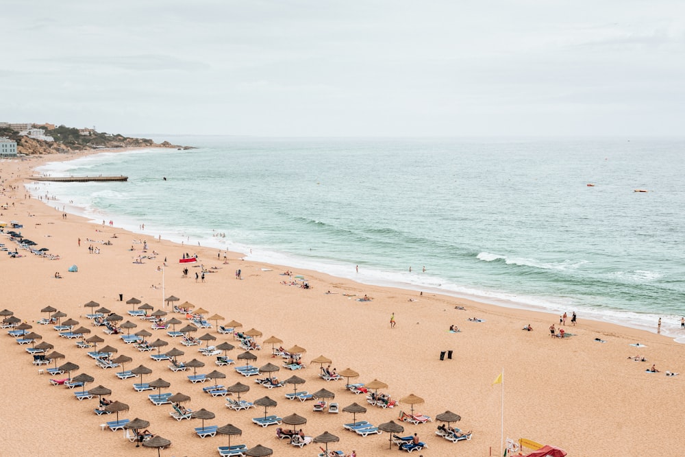 Une plage avec des gens et des parasols