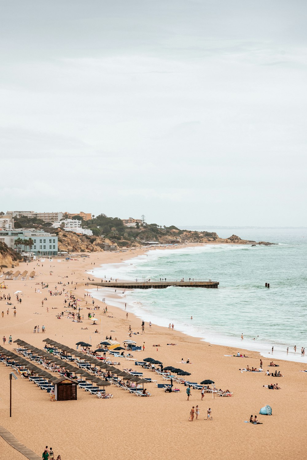 a beach with people and buildings