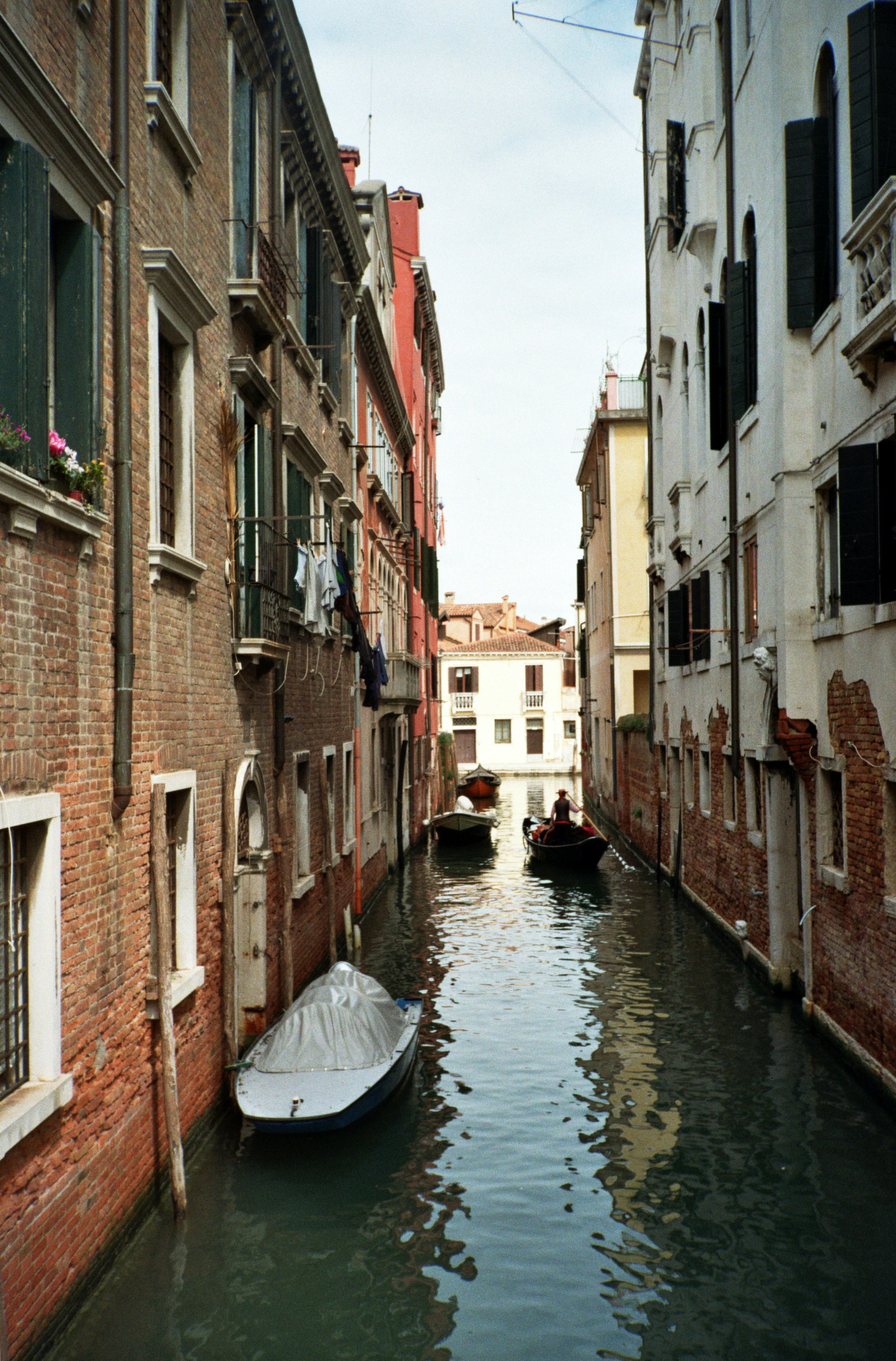 a boat in a canal between buildings
