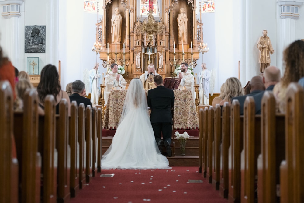 a bride and groom walking down the aisle